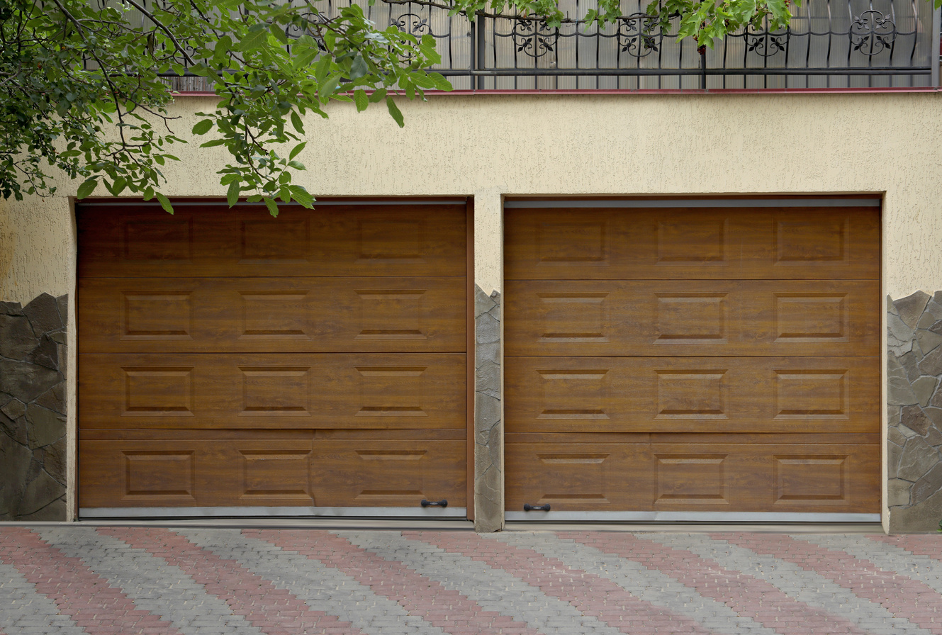 Building with Brown Sectional Garage Doors and Paved Driveway