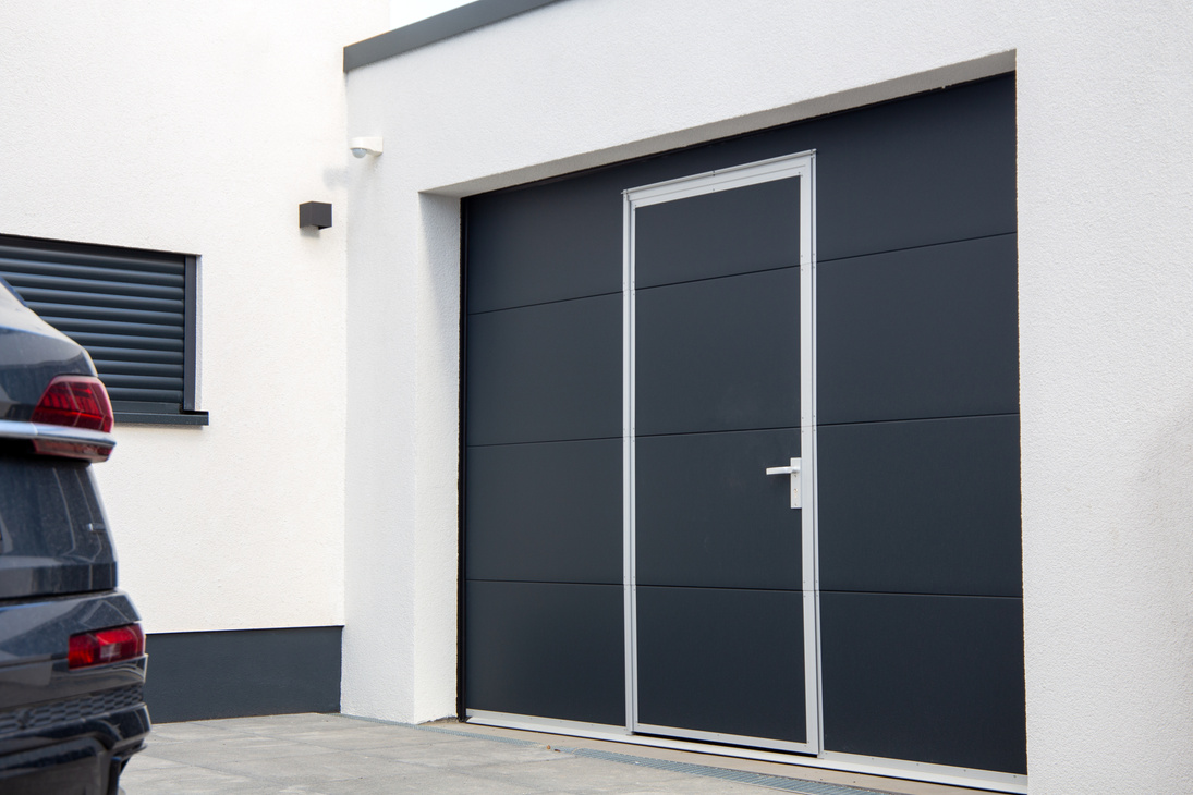 Modern new garage door (sectional door) with door